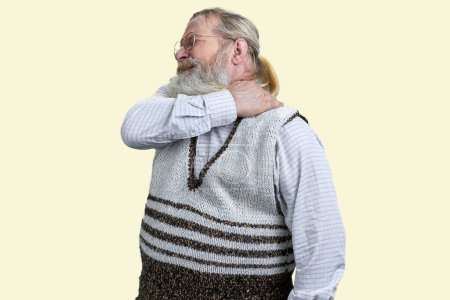 Photo for Old senior bearded man suffering from neckache. Isolated on white background. - Royalty Free Image