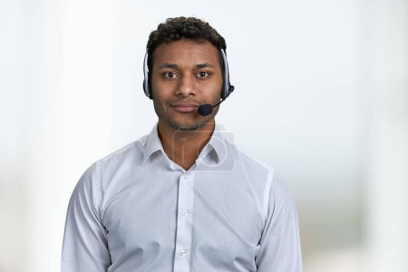 Photo for Handsome consultant of call center in headset looking at camera. Portrait of call center agent on blurred background. - Royalty Free Image