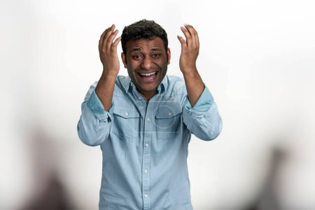 Photo for Happy laughing young man looking at camera standing on blurred background. Positive human expressions. - Royalty Free Image