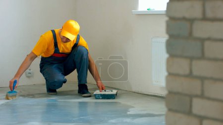 Photo for Builder processing concrete. Worker make renovation of apartment. - Royalty Free Image