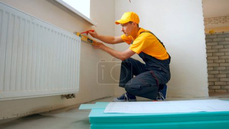Photo for Builder is making repairs in the apartment. Preparation of walls for repair. - Royalty Free Image