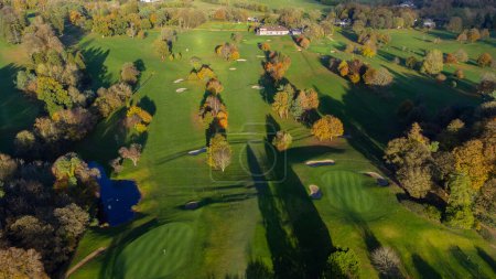 Foto de Aerial View of Mullingar golf course in Ireland on a sunny Autumn day, with long shadows and colors of autumn. - Imagen libre de derechos