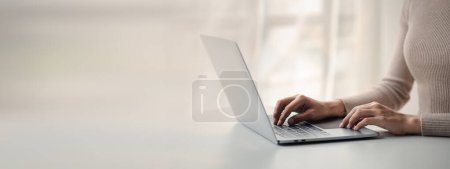 Photo for Person typing on laptop keyboard, businessman working on laptop, he is typing messages to colleagues and making financial information sheet to sum up the meeting. - Royalty Free Image