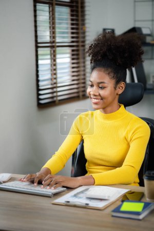 Photo for A young American woman is a start-up businesswoman, she in the office, managing and running a business from a young generation. Startup business management concept. - Royalty Free Image