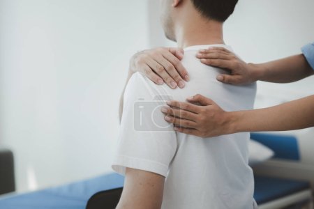 A physiotherapist doing physiotherapy for a patient in a hospital room, physiotherapy helps to recover from illness by moving the body and muscles. The concept of treating illnesses with physical therapy.