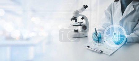Photo for Chemist taking notes on research data, Scientist is working in the laboratory, Chemist is analyzing experimental results and taking notes in the laboratory, lab idea. - Royalty Free Image