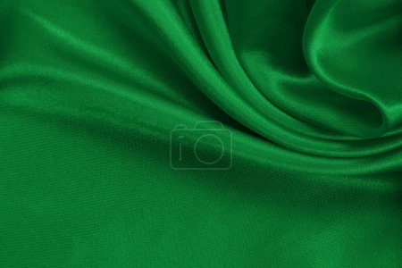Green emerald fabric texture background, detail of silk or linen pattern.