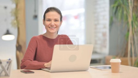 Photo for Young Woman Shaking Head in Acceptance While Working on Laptop - Royalty Free Image