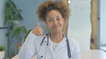 Photo for Call Me for Help Gesture by Female African Doctor - Royalty Free Image