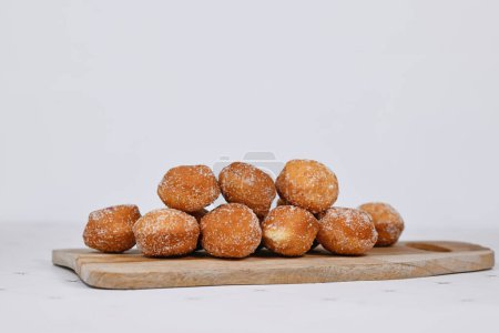 German traditional 'Berliner Pfannkuchen', a donut without hole filled with jam on wooden cutting board