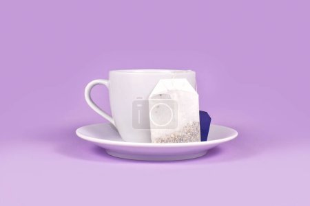 Tea cup with herbal tea bag on violet background