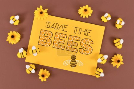 Photo for Save the Bees sign surrounded by felt bees and yellow flowers - Royalty Free Image