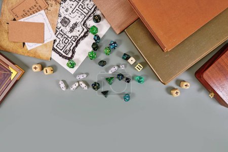 Photo for Tabletop roleplaying flat lay with RPG and game dices, rule book, notes and treasure map on gray background with copy space - Royalty Free Image
