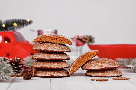 Stacks with halved traditional German round glazed gingerbread Christmas cookie called 'Lebkuchen' with seasonal decoration