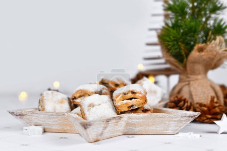 German Stollen cake pieces, a fruit bread with nuts, spices, and dried fruits with powdered sugar traditionally served during Christmas tim