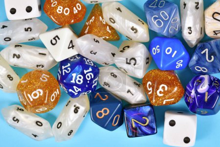 Photo for Different blue, white and golden roleplaying RPG dice - Royalty Free Image