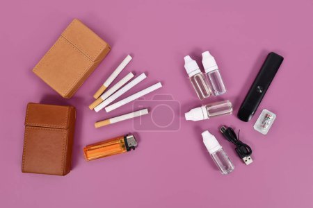 Comparison between electronic and real cigarette with tools on violet background