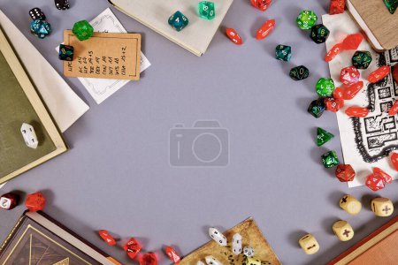 Tabletop role playing flat lay background with RPG dices, rule books, dungeon map and copy space in middl