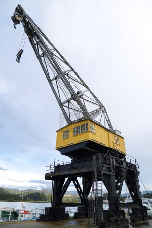 View of a port crane in the old industrial area of the town of San Esteban de Pravia, Asturias, Spain
