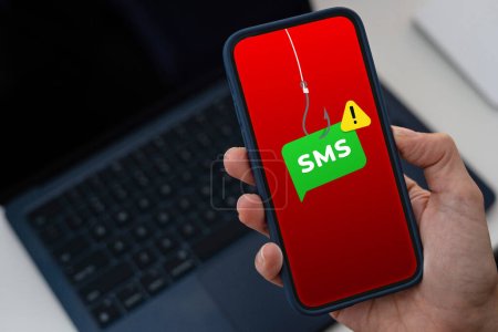 Smishing concept on a smartphone screen, text message scam