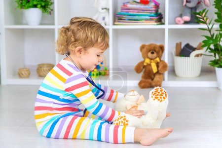 Photo for The child treats the bear plays. Selective focus. Kid. - Royalty Free Image