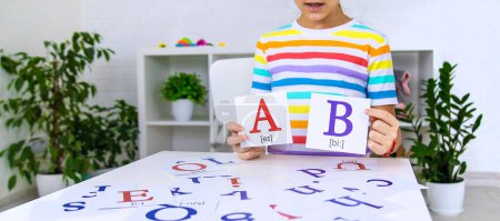 Photo for The child learns English letters. Selective focus. Kid. - Royalty Free Image