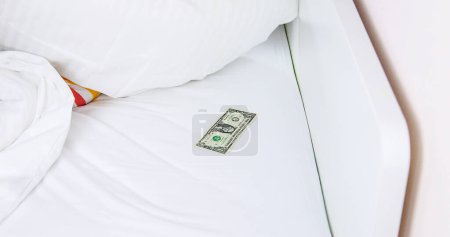 Photo for Dollar under the pillow in bed. Selective focus. White. - Royalty Free Image