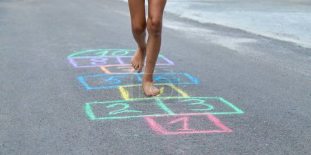 Photo for Children play hopscotch on the street. Selective focus. Nature. - Royalty Free Image