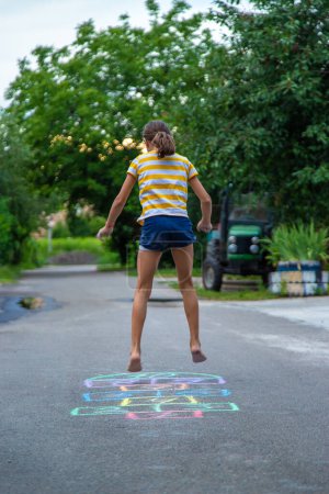 Photo for Children play hopscotch on the street. Selective focus. Nature. - Royalty Free Image