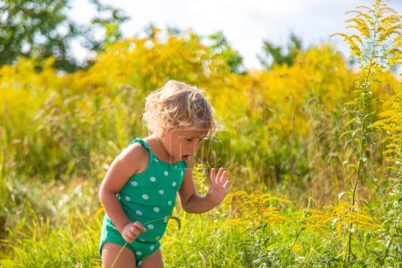 A child is allergic to ragweed blooming in the park. Selective focus. Nature.