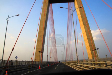 Photo for The driver's perspective when crossing the Suramadu bridge, a sturdy building construction with a barrier-free asphalt road. - Royalty Free Image