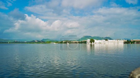 Photo for Lake Pichola with cloudy sky and aravali hills background in Udaipur, Rajasthan, India. An artificial lake popular for boat riding among tourist. Ornate sail boat. City of lakes. - Royalty Free Image