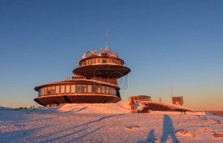 Winter, sunrise time,  disc shaped meteorological observatory in snezka, mountain on the border between Czech Republic and Poland.
