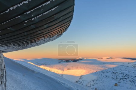 Winter, sunrise time,  roof of disc shaped meteorological observatory in snezka, mountain on the border between Czech Republic and Poland.