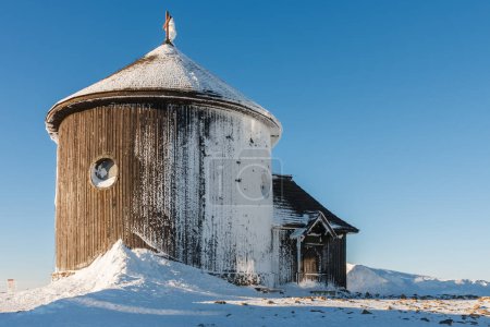 Winter morning,  wooden Roman catholic chapel in snezka, mountain on the border between Czech Republic and Poland.