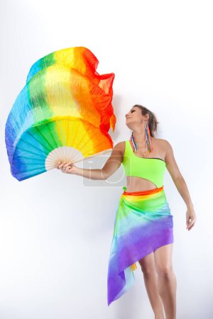 Photo for Young Brazilian woman dancing, isolated on a white background, with a colorful fabric in hand - Royalty Free Image