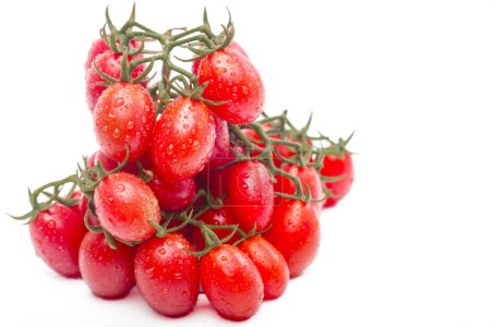 Photo for Frontal View of Mature Cherry Tomatoes Stacked on a White Surface - Royalty Free Image