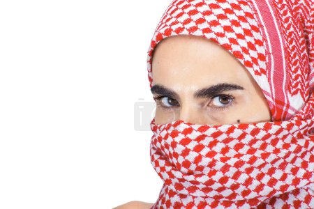 Photo for Woman with a Scarf Veiling her Face and a Striking Gaze - Royalty Free Image
