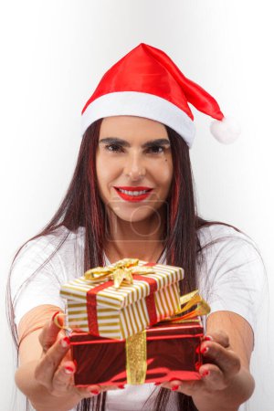 Photo for Woman with Christmas hat, gifts in hand, and white background - Royalty Free Image