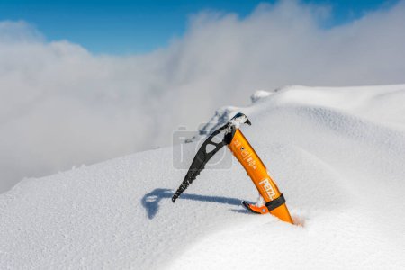 Photo for Zakopane, Poland - March 17, 2024: Petzl Gully ice axe in the snow on a peak in the mountains. - Royalty Free Image
