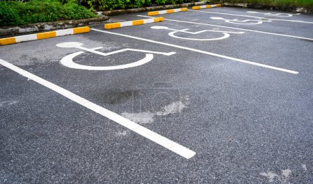 Photo for White handicapped symbol painted on asphalt floor special lane parking. Disabled parking spaces. traffic sign about handicaps - Royalty Free Image