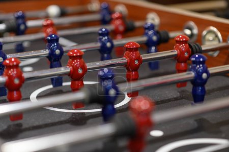 Photo for Close-up plastic players in table football in entertainment center. Soccer table with red and blue players - Royalty Free Image