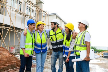 Foto de Group of happy contractors, engineers and formats in safety vests with helmets stand on the under-construction building site. teamwork concept - Imagen libre de derechos