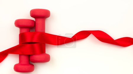 Red dumbbells with a red ribbon on a white background. Copy space. The concept of a sports holiday.