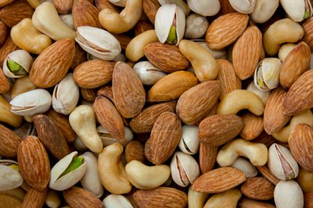 Photo for Mixed nut background. Cashews, almonds and pistachios. Concept of healthy eating. - Royalty Free Image