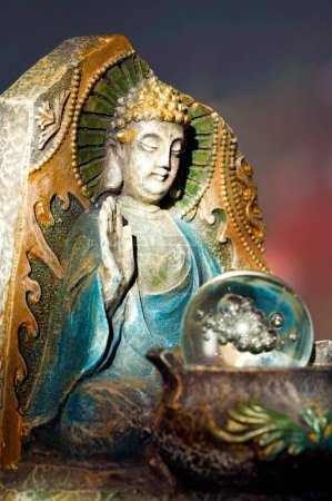 Photo for Meditating Buddha Statuette with Cauldron and Glass Ball - Royalty Free Image