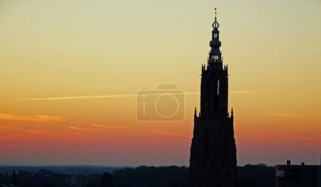 Photo for Silhouette of the famous 'Onze-Lieve-Vrouwetoren' (the tower of our lady) at sunset in Amersfoort, Netherlands - Royalty Free Image