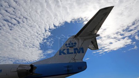 Photo for Schiphol, The Netherlands - August 14 2023: The tail of a Fokker 100 airplane from KLM against a blue sky with clouds - Royalty Free Image