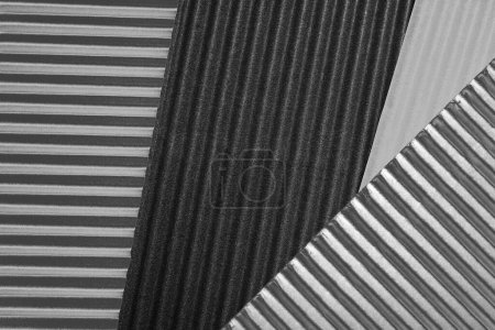 Photo for Horizontally and diagonally ribbed cardboard with shades of gray. Meant as background - Royalty Free Image