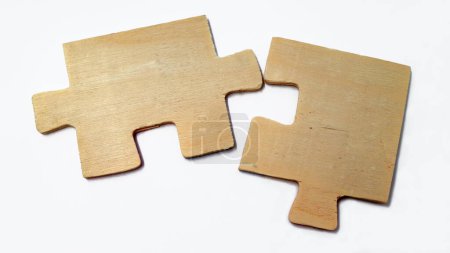 Photo for Fitting wooden puzzle pieces isolated on a white background. Concept of business solution, solving a problem. - Royalty Free Image